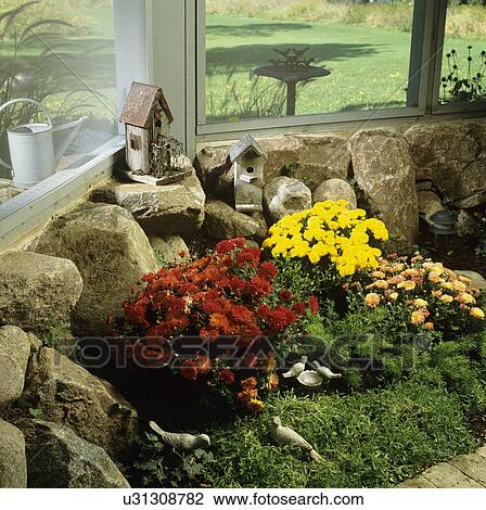 PORCH: inside of screened porch underneath deck, flower border along rock foundation wall and screening, mums, looking out into yard View Large Photo Image Stock Image - PORCH: inside of screened porch underneath deck, flower border along rock foundation wall and screening, mums, looking out into yard. Fotosearch