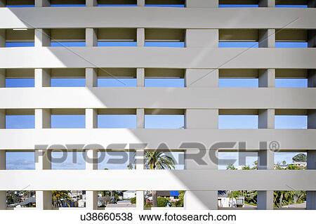 Stock Photo - Privacy wall with view of town and blue sky. Fotosearch