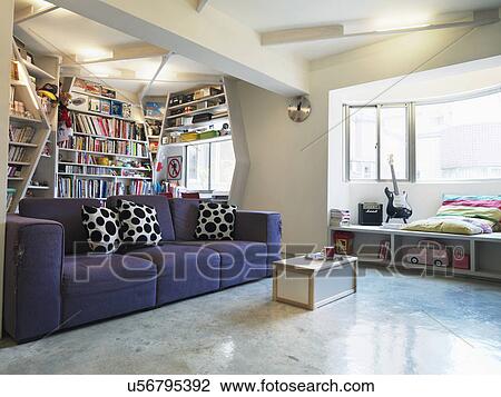 Stock Image - Purple sofa in compact apartment; Taipei; Taiwan. Fotosearch