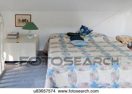Picture - Quilt on bed in traditional bedroom. Fotosearch