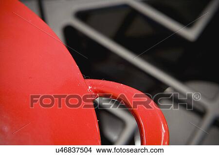 Picture - Red cooking pot on range; Aliso Viejo; California; USA. Fotosearch