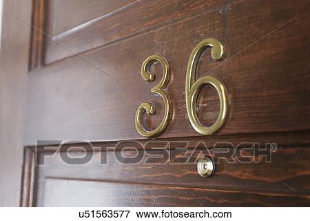 Stock Photo - Room number on wooden door, Ojo Caliente, New Mexico, USA. Fotosearch