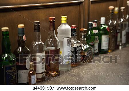 Row of liquor on countertop; Irvine; California; USA View Large Photo Image Stock Photo - Row of liquor on countertop; Irvine; California; USA. Fotosearch
