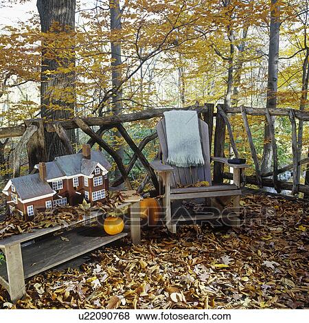 SEASONS - FALL: Leaves cover balcony deck of rustic tree house adjacent to indoor living area, birdhouse on bench. Adirondack style chair. View Large Photo Image Stock Photo - SEASONS - FALL: Leaves cover balcony deck of rustic tree house adjacent to indoor living area, birdhouse on bench. Adirondack style chair. . Fotosearch