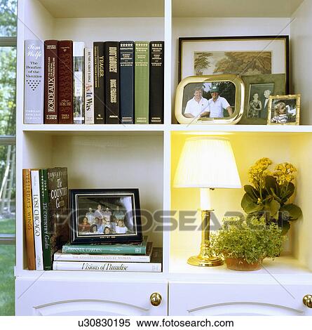Stock Photography - Shelves in a traditional home with books and photos. Fotosearch