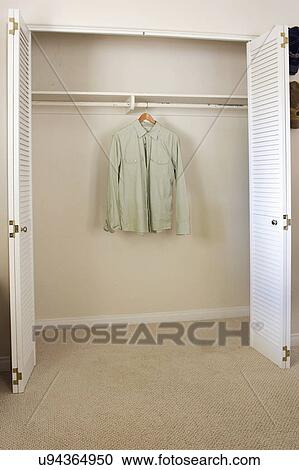 Shirt hanging in empty closet, San Diego, California, United States of America View Large Photo Image Stock Image - Shirt hanging in empty closet, San Diego, California, United States of America. Fotosearch