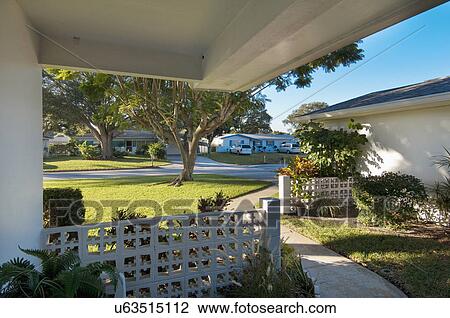 Stock Image - Sidewalk through front yard of average home. Fotosearch