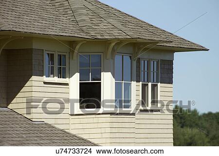 Picture - Single family home with shingled rooftop. Fotosearch