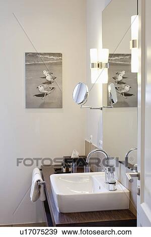 Stock Photo - Sink on wooden countertop in domestic bathroom. Fotosearch