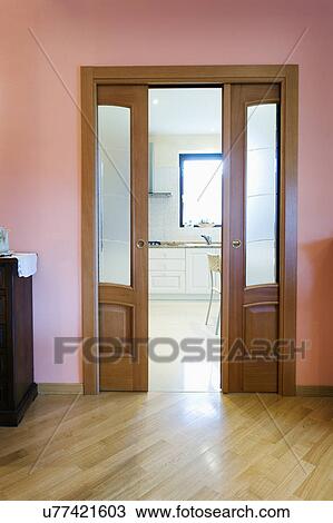Stock Image - Sliding double doors in home; Italy. Fotosearch