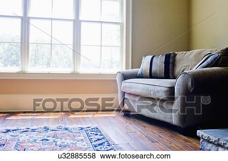 Sofa and area rug on hardwood floor in traditional room View Large Photo Image Stock Photo - Sofa and area rug on hardwood floor in traditional room. Fotosearch