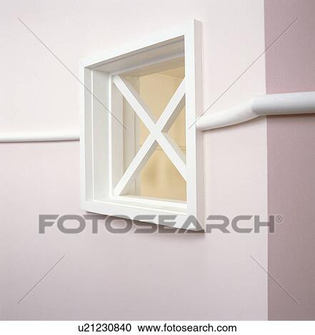 Stock Image - Square shaped window on pale pink walls. Fotosearch