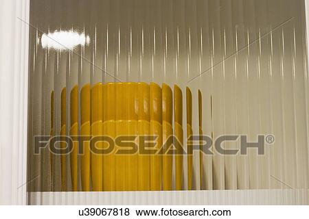 Stock Photo - Stack of bowls behind glass cabinet door; Aliso Viejo; California; USA. Fotosearch