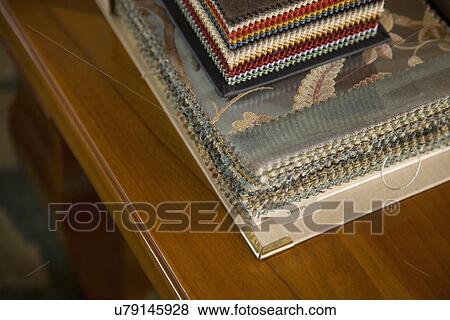 Stock Photo - Stack of fabric swatches on coffee table; Carpinteria; California; USA. Fotosearch