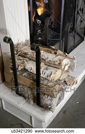 Stack of firewood by fireplace with metal grate View Large Photo Image Stock Image - Stack of firewood by fireplace with metal grate. Fotosearch