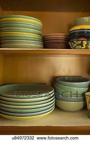 Stacks of dishes and bowls on shelves in cabinet; Carpinteria; California; USA View Large Photo Image Stock Image - Stacks of dishes and bowls on shelves in cabinet; Carpinteria; California; USA. Fotosearch