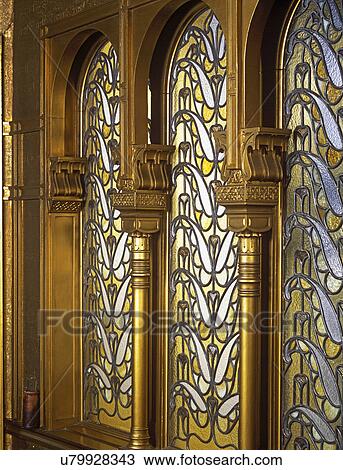 STAINED GLASS: Detail of stained glass windows in Turkish nook. Ornate gold gilded trim work around windows, amber and white pattern in glass. View Large Photo Image Stock Image - STAINED GLASS: Detail of stained glass windows in Turkish nook. Ornate gold gilded trim work around windows, amber and white pattern in glass. . Fotosearch