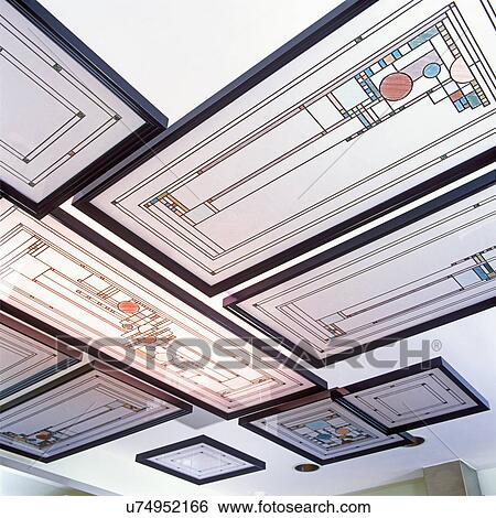 Stock Photograph - STAINED GLASS WINDOWS - Detail of creative use of stained glass windows in a kitchen. Windows are suspended from ceiling. Windows are Frank Lloyd Wright design. . Fotosearch