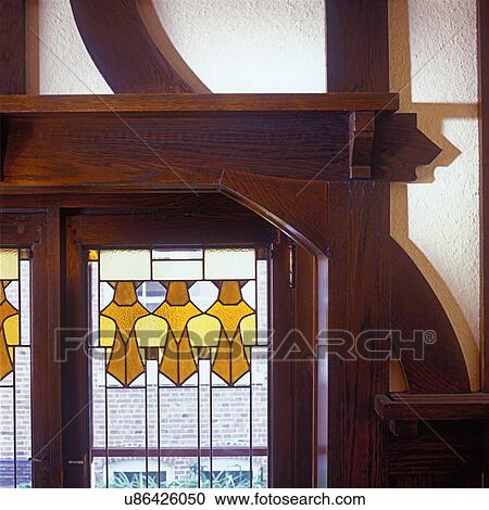 Stock Image - STAINED GLASS WINDOWS: Detail, stained glass and leaded window in Arts & Crafts home, 1905, clear glass with amber and yellow geometric design at top.. Fotosearch