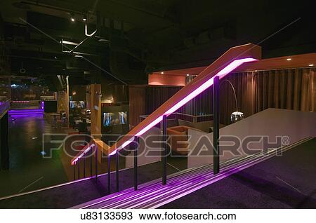 Stock Image - Staircase leading down to lounge area in nightclub. Fotosearch
