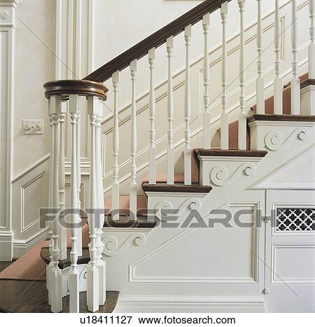 STAIRWAYS: Close up of classic Georgian style banister and decorative risers, carpet runner, white painted trim, dado and other moldings. View Large Photo Image Stock Photo - STAIRWAYS: Close up of classic Georgian style banister and decorative risers, carpet runner, white painted trim, dado and other moldings. . Fotosearch
