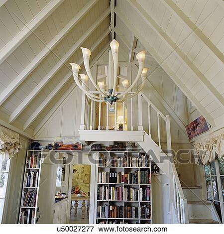 stairways: shabby chic cottage style, white foyer area with simple open staircase leading up to bedroom, built in book cases, Italian calla lily chandelier, cathedral ceiling View Large Photo Image Stock Photo - stairways: shabby chic cottage style, white foyer area with simple open staircase leading up to bedroom, built in book cases, Italian calla lily chandelier, cathedral ceiling. Fotosearch