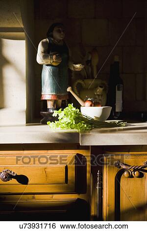 Statue and cooking supplies on kitchen counter View Large Photo Image Stock Photograph - Statue and cooking supplies on kitchen counter. Fotosearch