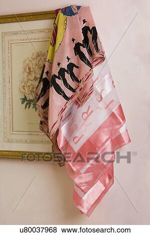 Stock Photo - STILL LIFE: pink scarves draped over a botanical print. Fotosearch