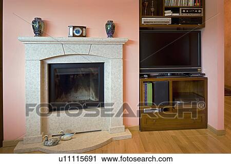 Stock Image - Stone fireplace in average home; Italy. Fotosearch