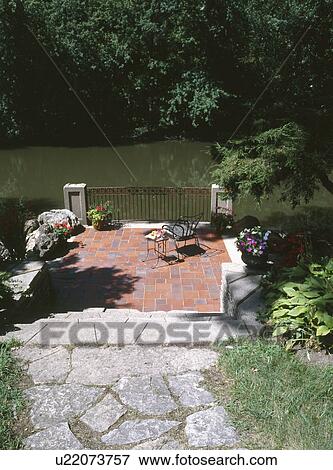 Stone Path Leading To Patio By River Stock Photo U22073757