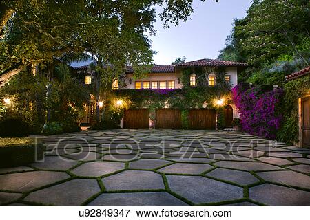 Stock Photo - Stone shape tiled driveway in front of a Spanish style home, Montecito, California, USA. Fotosearch