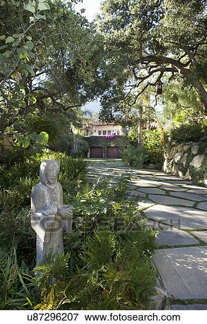 Stock Photo - Stone statue at driveway leading to home, California, USA. Fotosearch