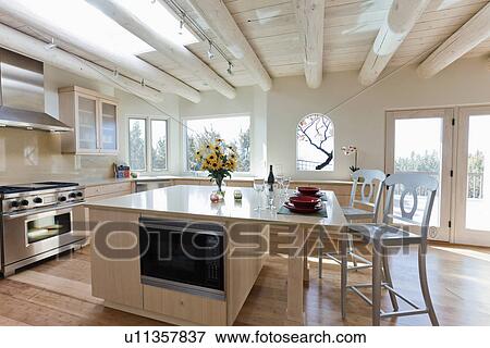 Stools at breakfast bar in contemporary kitchen, Santa Fe, New Mexico, USA View Large Photo Image Stock Photo - Stools at breakfast bar in contemporary kitchen, Santa Fe, New Mexico, USA. Fotosearch