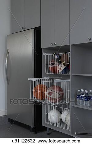 Storage Garage Area With Stainless Steel Refrigerator Pullout