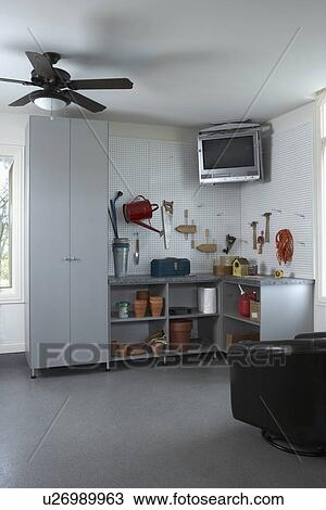 Storage Garage Organization Corner With Tv Suspended Above Peg