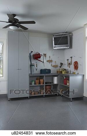 Storage Garage Organization Corner With Tv Suspended Above Peg