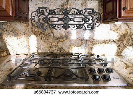 Stock Photo - Stove top and marble backsplash; Laguna Beach; California; USA. Fotosearch