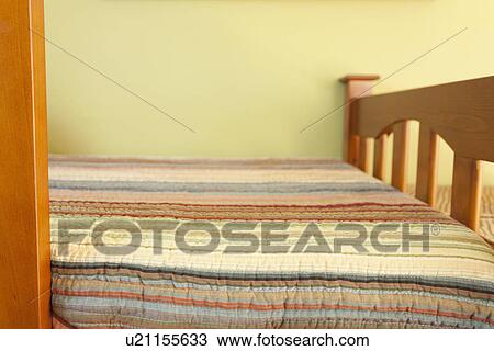 Stock Image - Striped comforter on kids bed; Burbank; California; USA. Fotosearch