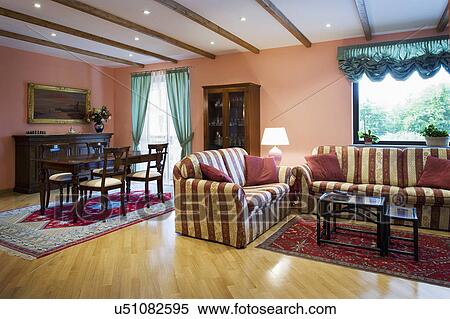 Stock Photography - Striped sofas in traditional living room; Italy. Fotosearch