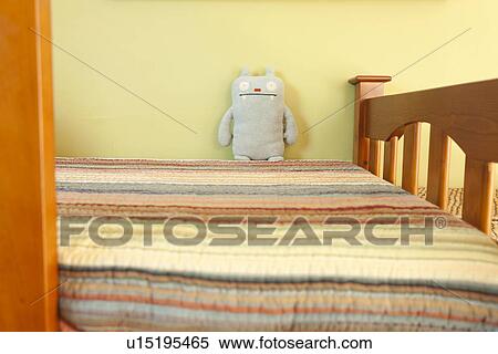 Stock Photography - Stuffed animal on child's bed; Burbank; California; USA. Fotosearch