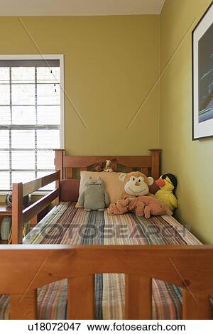 Stock Photo - Stuffed animals on kids bed; Burbank; California; USA. Fotosearch
