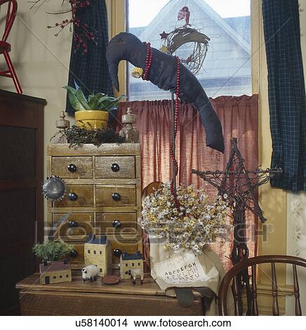 Picture - Stuffed fabric crow perched over table with creative collectibles. Fotosearch