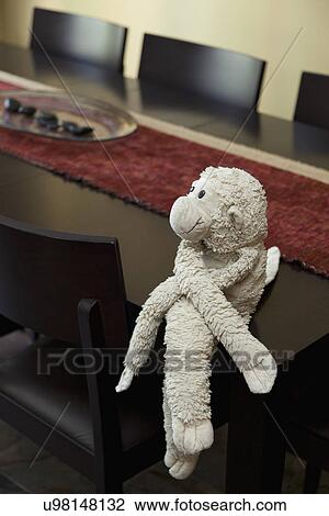 Stuffed monkey on contemporary dining table; Burbank; California; USA View Large Photo Image Stock Image - Stuffed monkey on contemporary dining table; Burbank; California; USA. Fotosearch