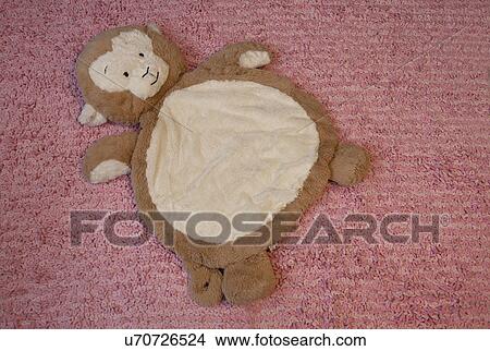 Stuffed monkey on pink rug, Laguna Beach, California, USA View Large Photo Image Picture - Stuffed monkey on pink rug, Laguna Beach, California, USA. Fotosearch