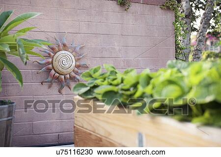 Sun shaped sculpture on a wall at yard View Large Photo Image Stock Image - Sun shaped sculpture on a wall at yard. Fotosearch