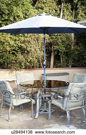 Sunshade and chairs on patio View Large Photo Image Stock Photo - Sunshade and chairs on patio. Fotosearch