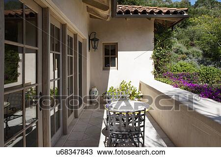 Stock Image - Table and chairs at porch; California; USA. Fotosearch