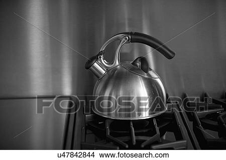 Tea Kettle on stainless steel oven; Irvine; California; USA View Large Photo Image Picture - Tea Kettle on stainless steel oven; Irvine; California; USA. Fotosearch