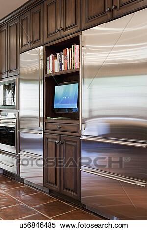 Television between two stainless steel refrigerators; Irvine; California; USA View Large Photo Image Stock Photography - Television between two stainless steel refrigerators; Irvine; California; USA. Fotosearch