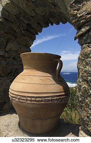 Stock Photography - Terra cotta jug in cutout of wall, Mykonos, Greece. Fotosearch